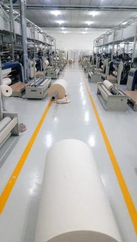 Yellow epoxy lane marking applied on a factory floor in Faisalabad